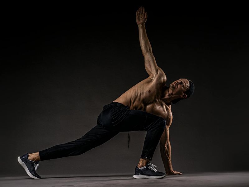 Person performing a stretching exercise in a minimalist environment.
